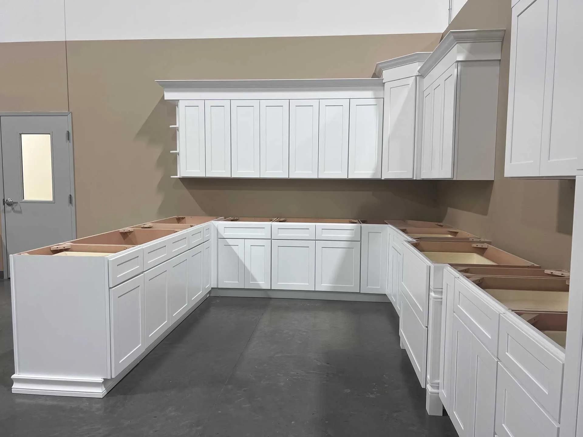 A kitchen with a lot of white cabinets and sinks