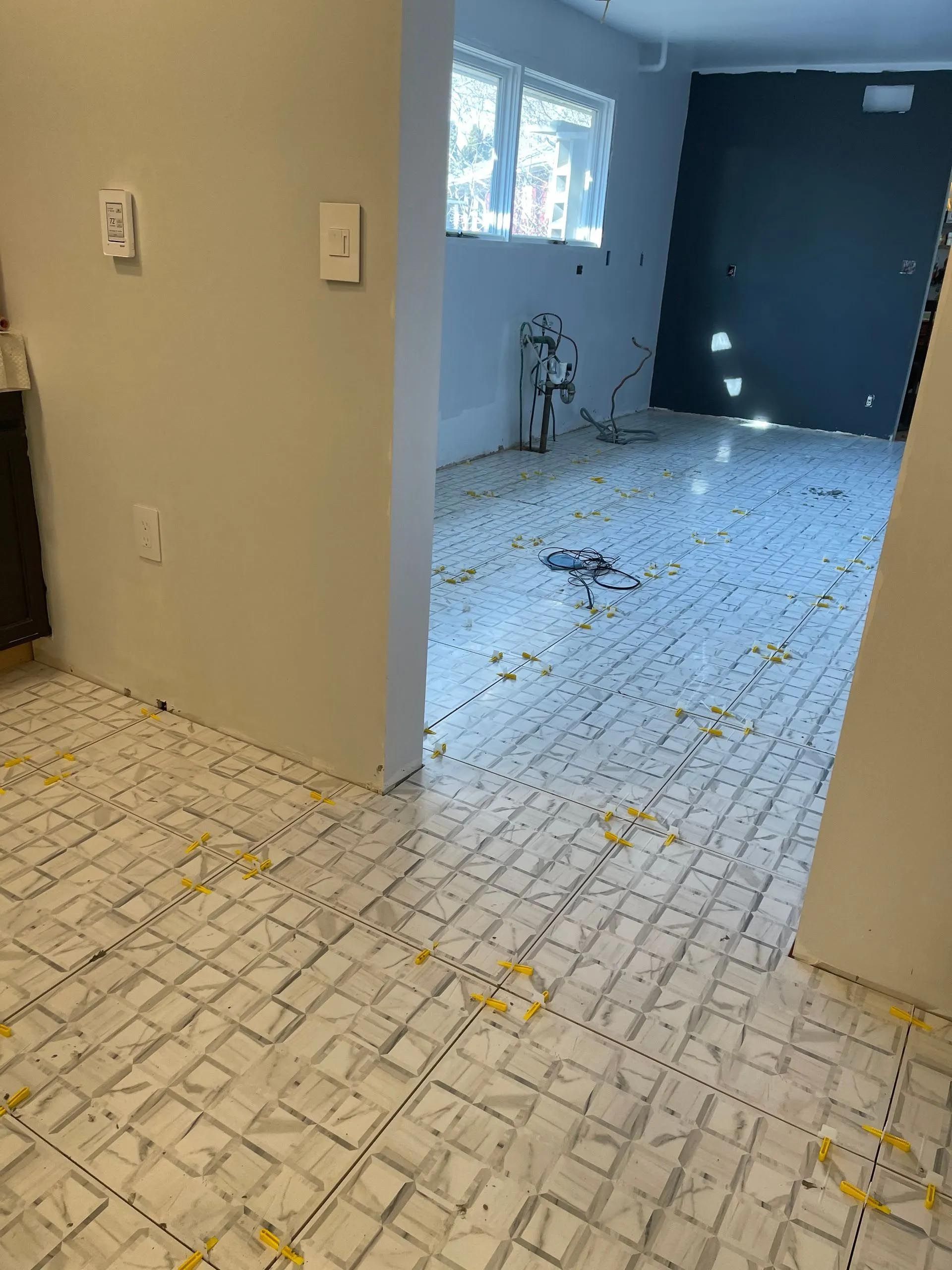 A room with a tiled floor and a window.