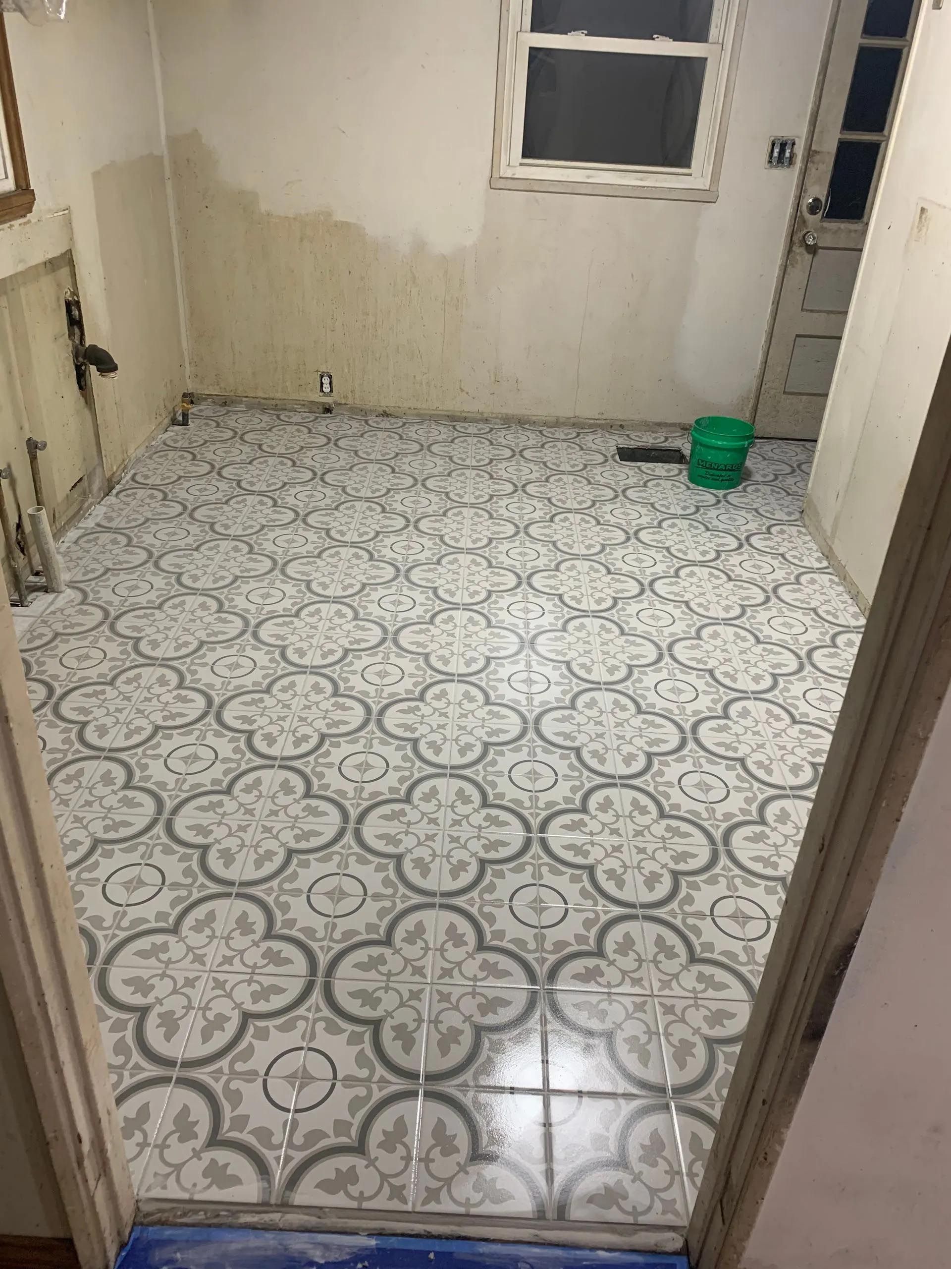 A room with a tiled floor and a window.