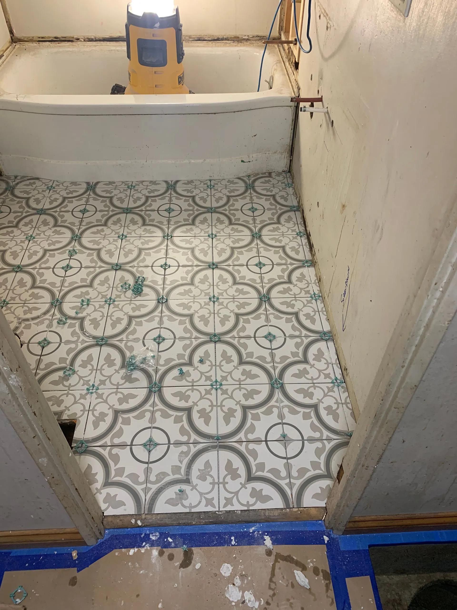 A bathroom with a bathtub and a tiled floor.