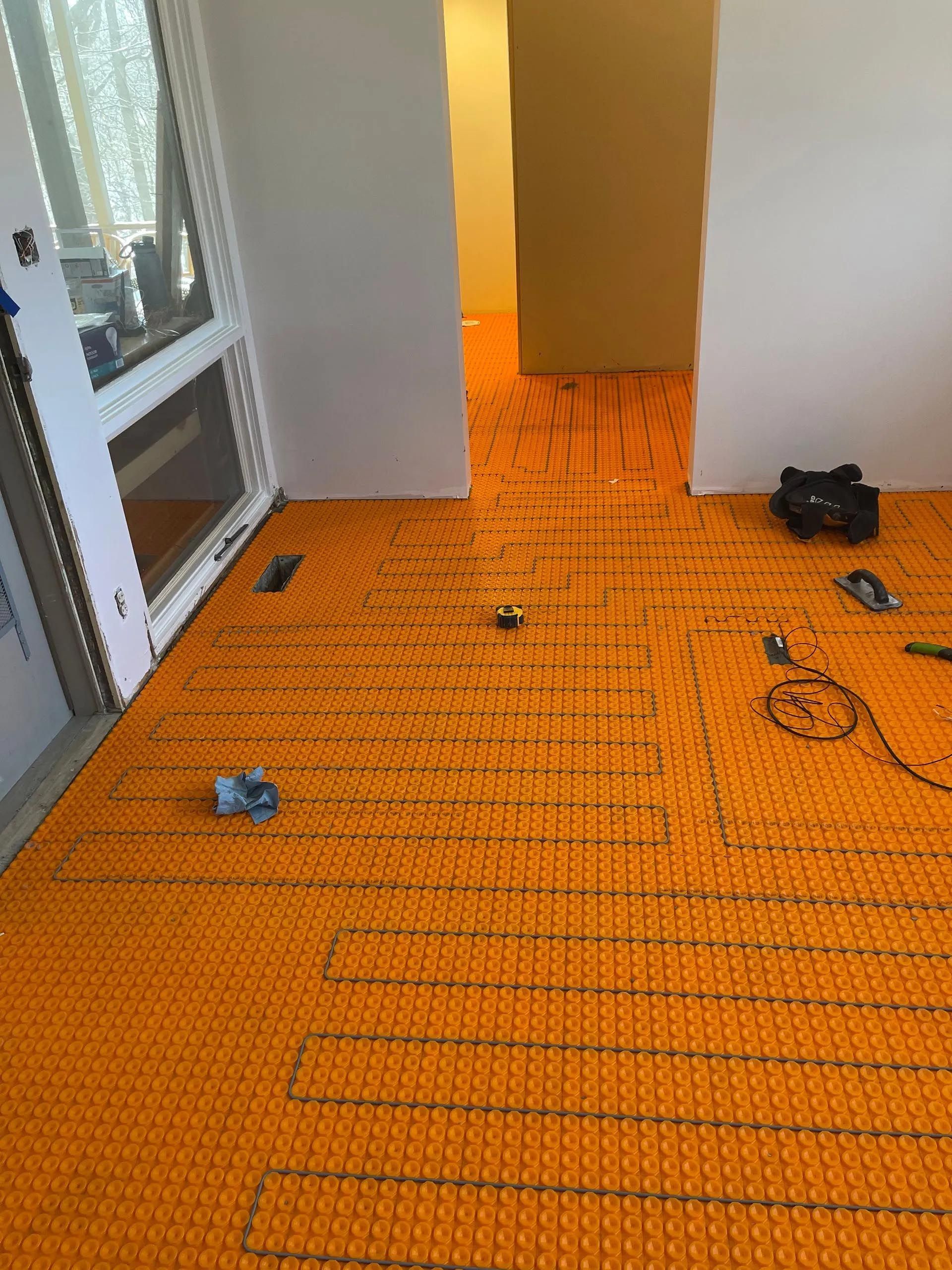 A room with a lot of orange tiles on the floor.