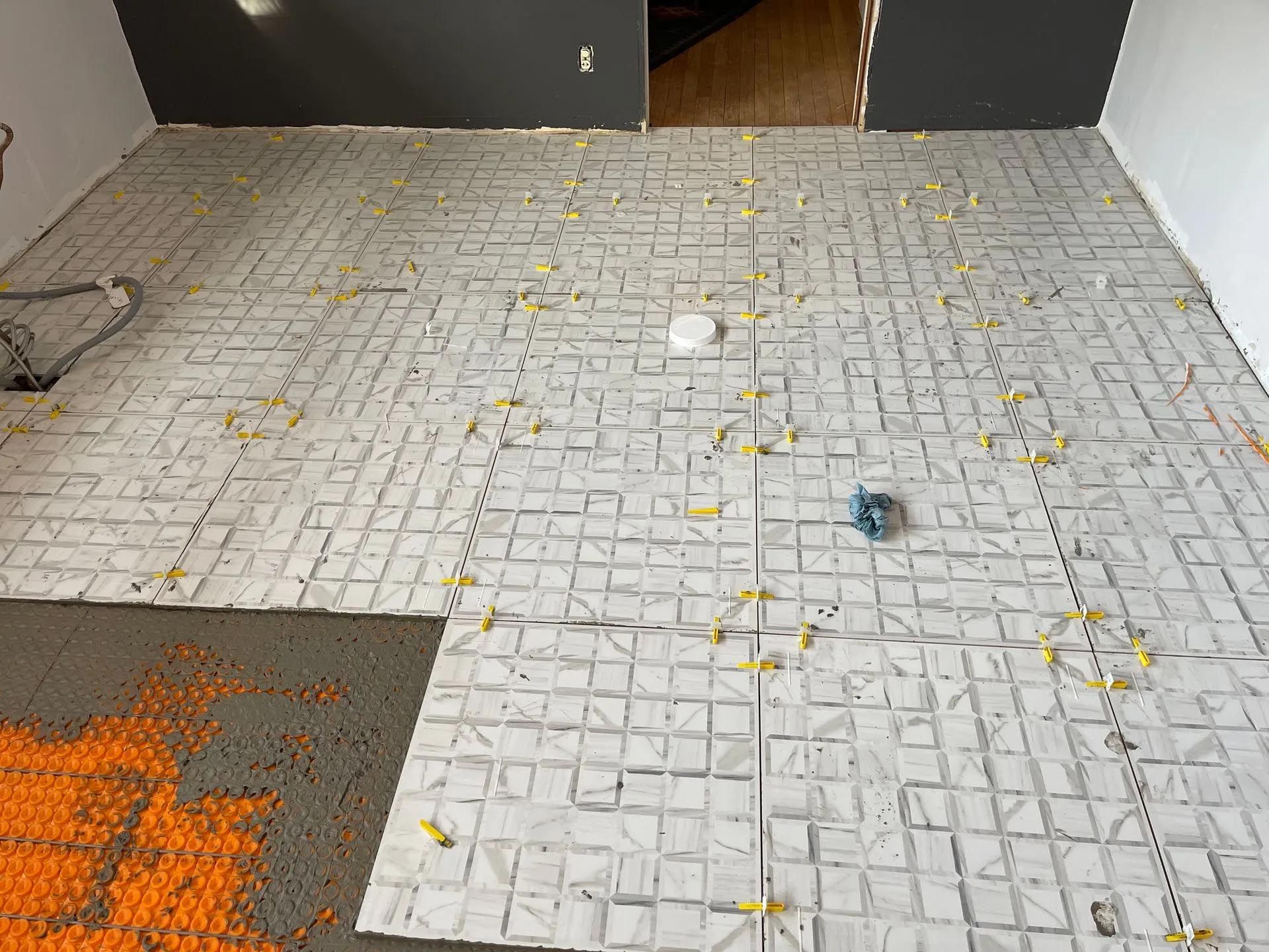 A brick floor is being installed in a room.