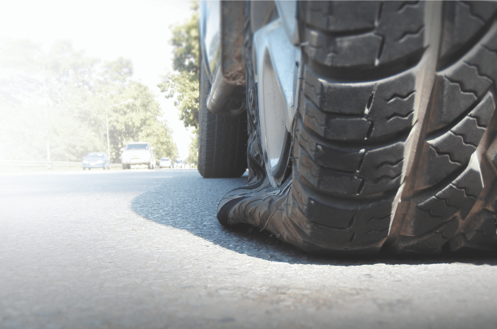 Picture of a truck with a flat tire needing road side assistance