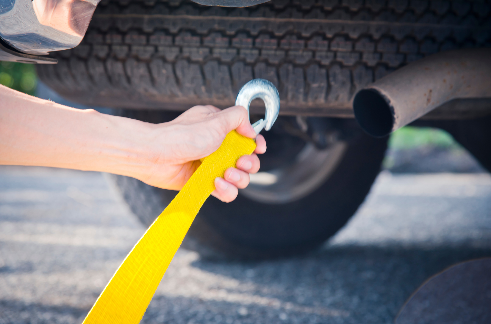 Maple Ridge Towing hooking up a broken down vehicle with a winch