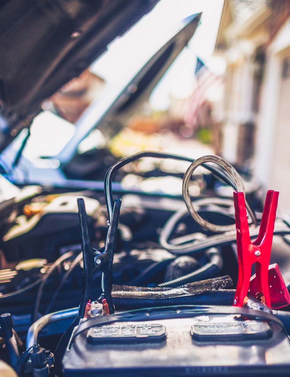 Jumper cables hooked up to a batter on the positive and negative terminal