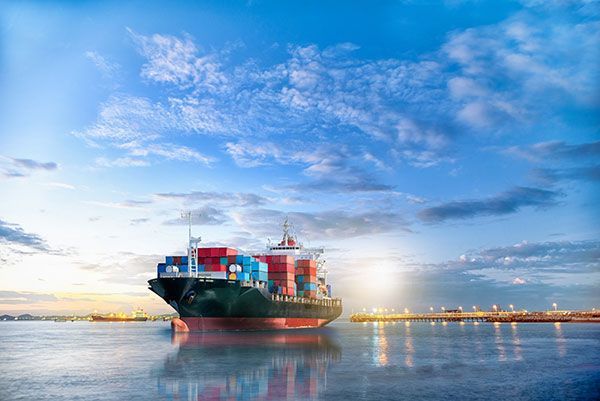 A large container ship is floating on top of a body of water.