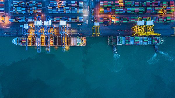 An aerial view of a container ship in a harbor at night.