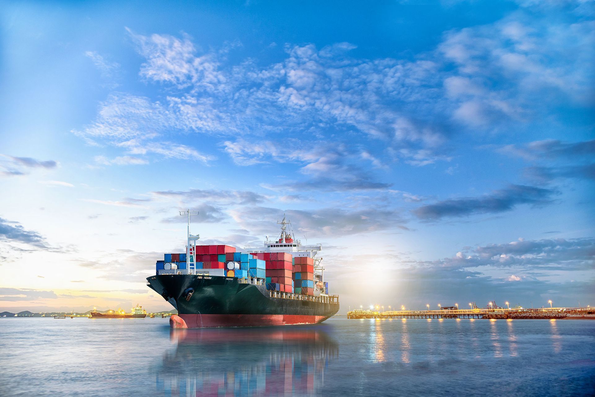 A large container ship is floating on top of a body of water.