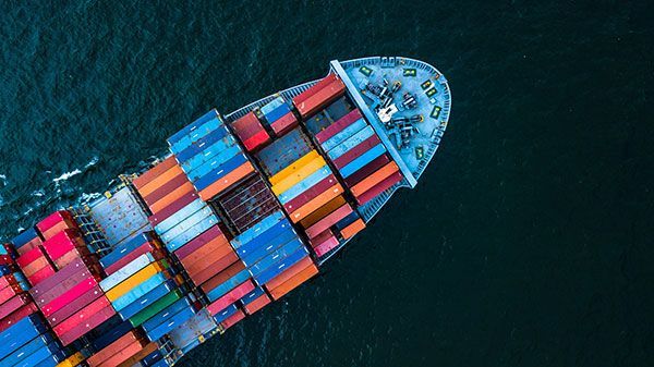 An aerial view of a large container ship floating on top of a body of water.