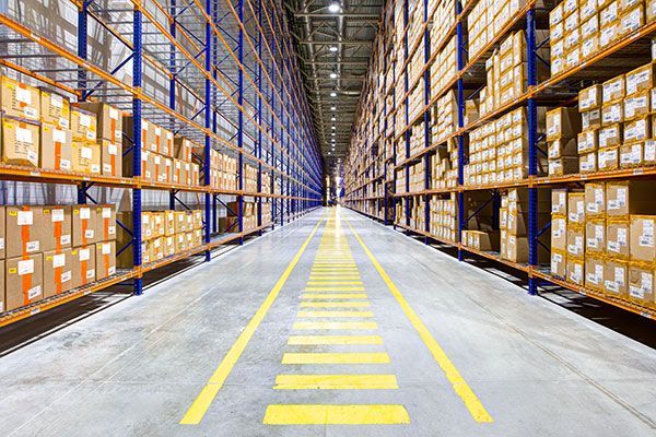 A large warehouse filled with lots of boxes and shelves.