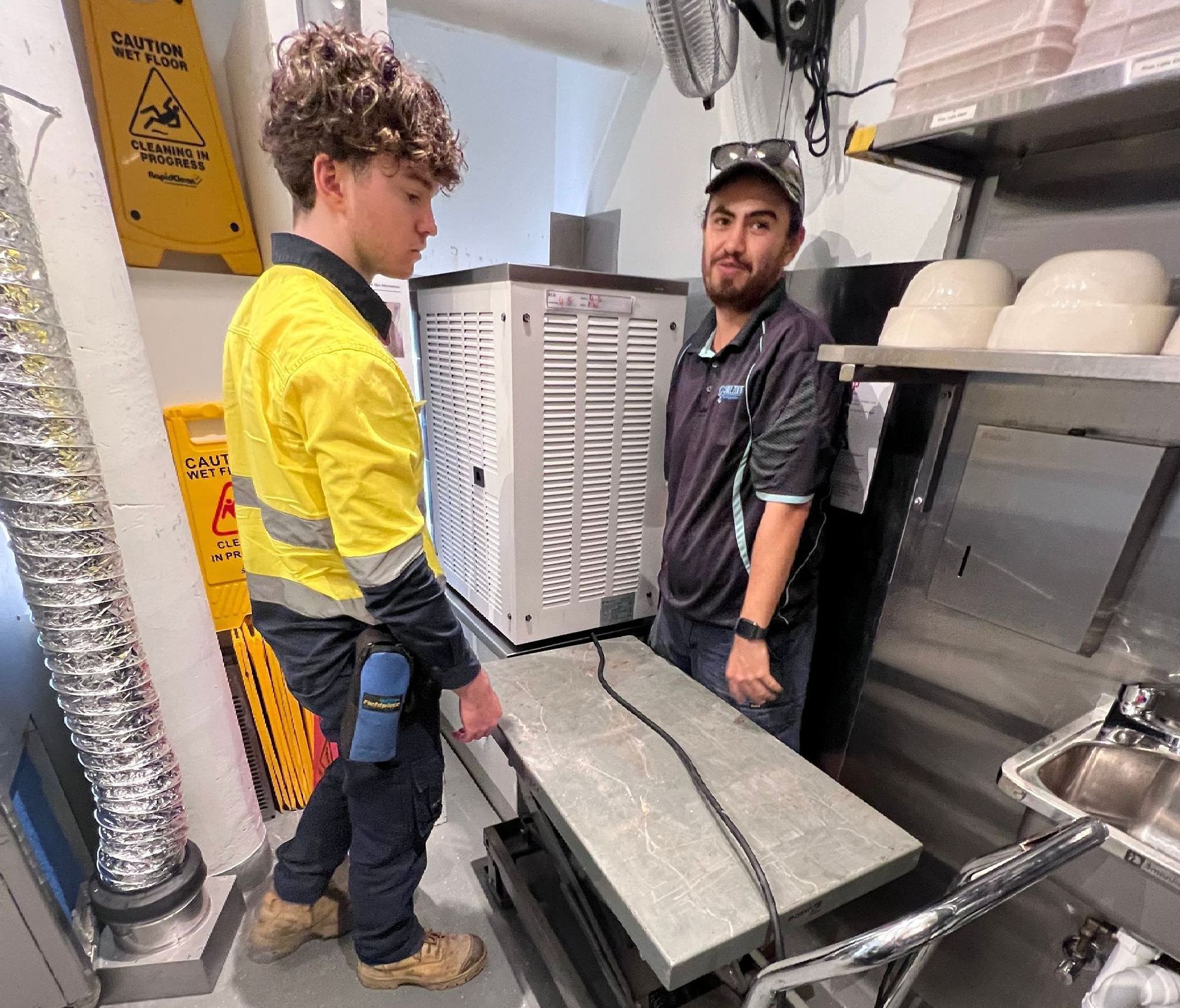 An Empty Refrigerator With Stainless Steel Shelves in a Kitchen — Chillzone Refrigeration and Air Conditioning in Landsborough, QLD