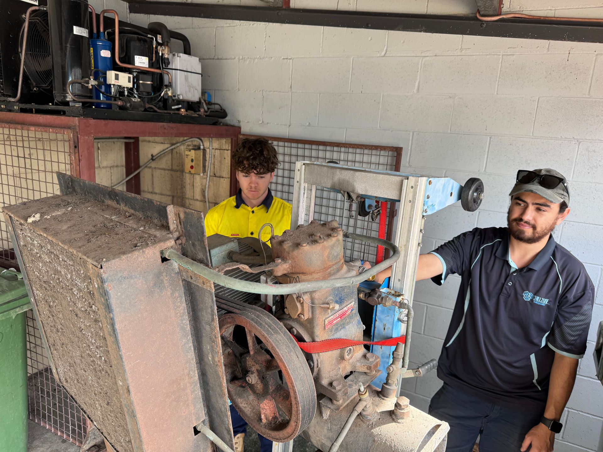 A Refrigerator Filled With Ice and a Fan on a Green Background — Chillzone Refrigeration and Air Conditioning in Maleny, QLD