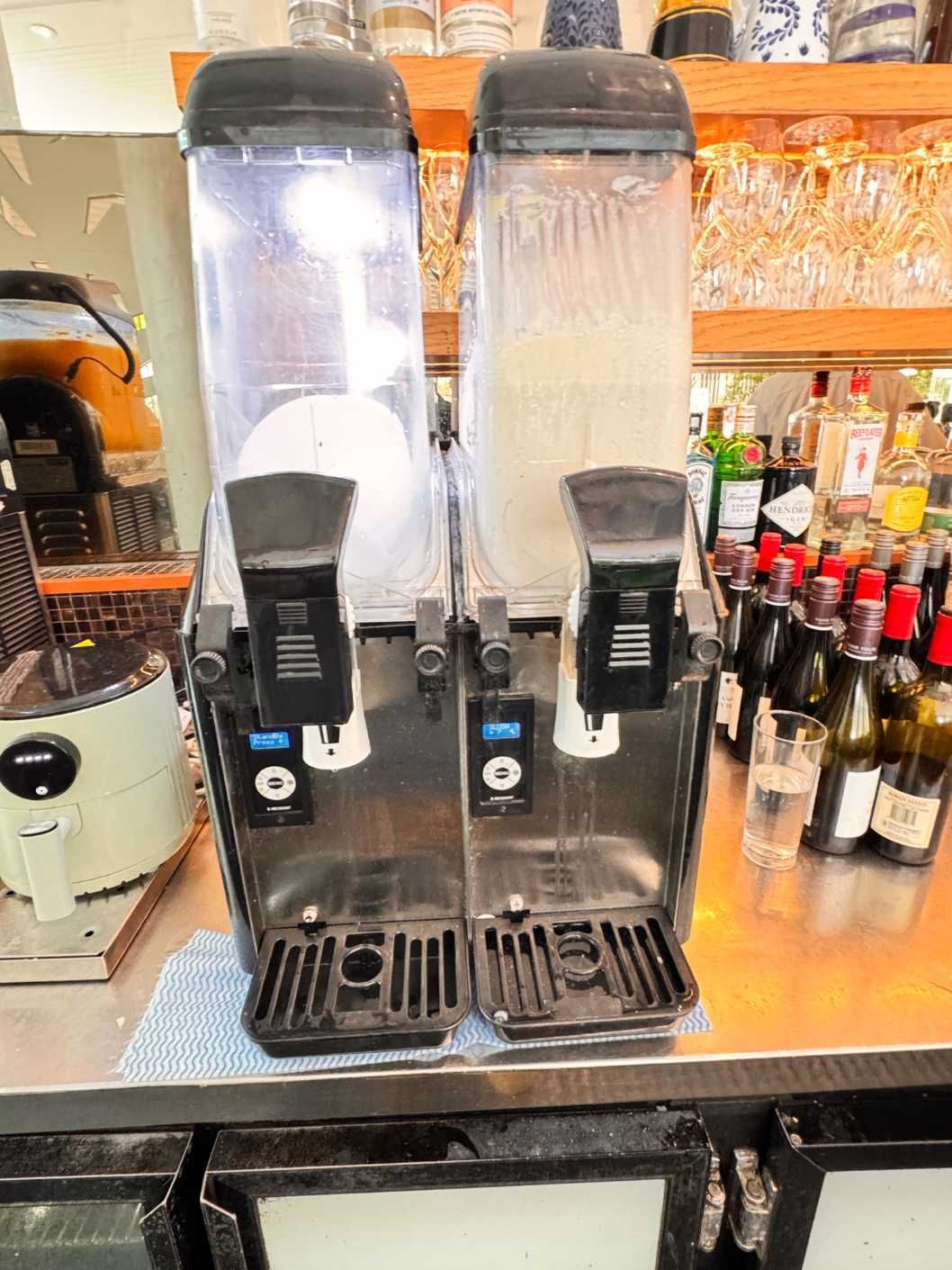 Two Drink Dispensers Are Sitting on a Counter in a Restaurant — Chillzone Refrigeration and Air Conditioning in Landsborough, QLD