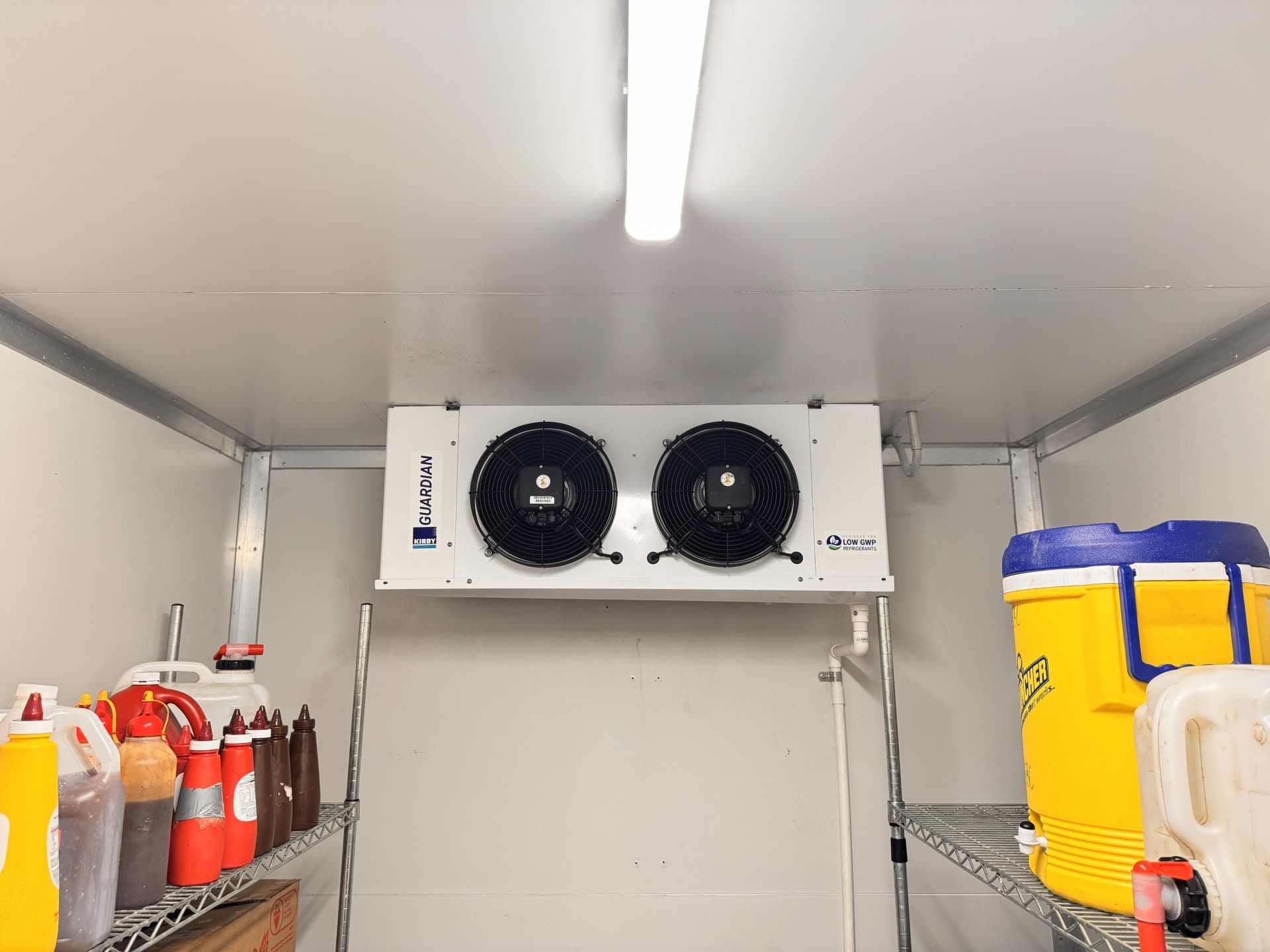 A Kitchen With Stainless Steel Appliances and a Stove — Chillzone Refrigeration and Air Conditioning in Morayfield, QLD