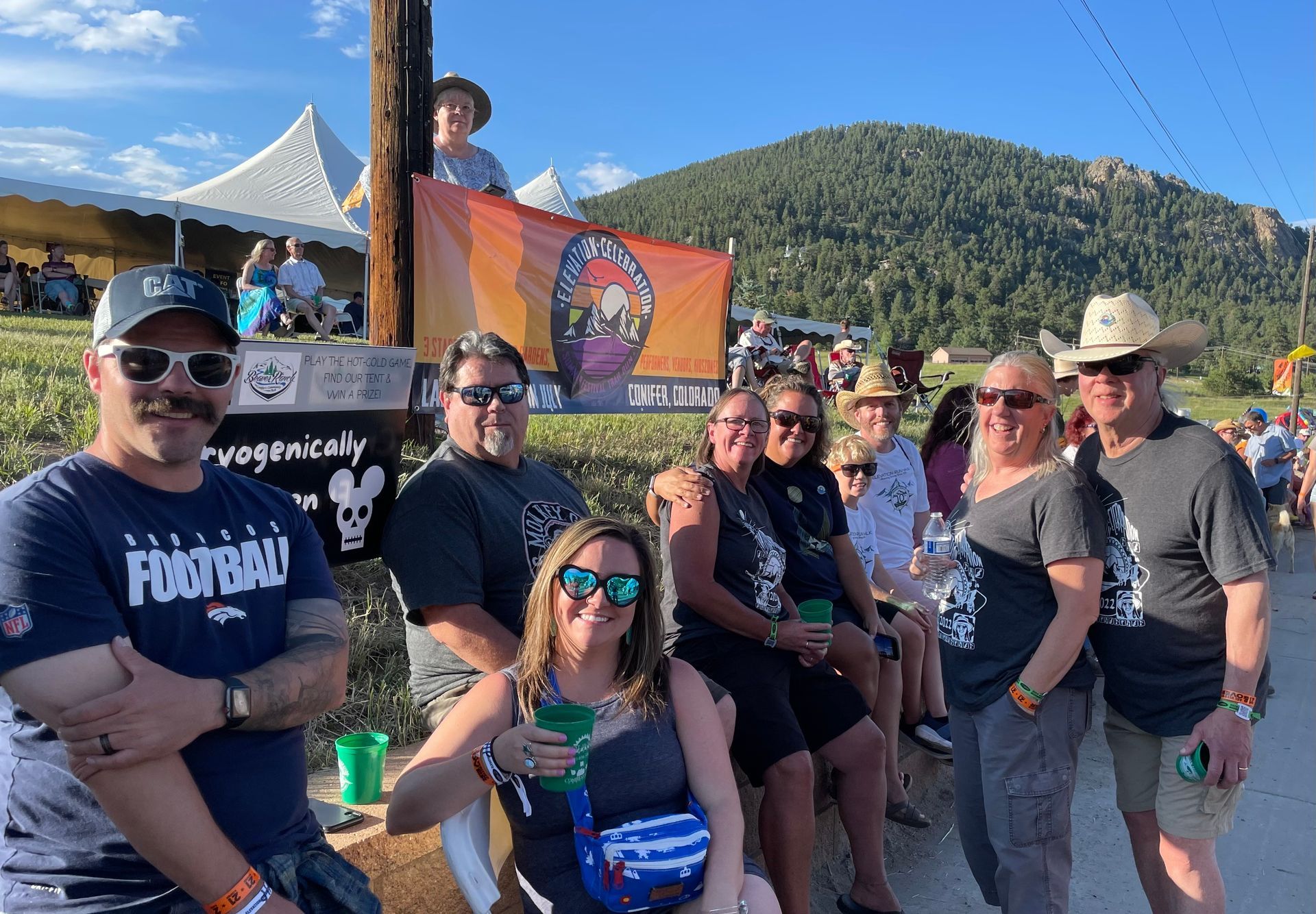 A group of people standing next to each other in front of a mountain.
