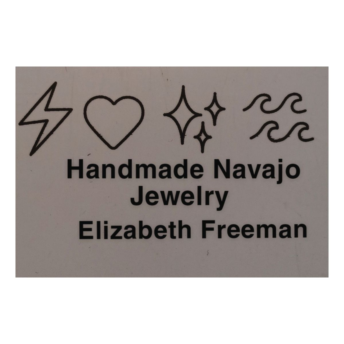 A sign that says handmade navajo jewelry elizabeth freeman