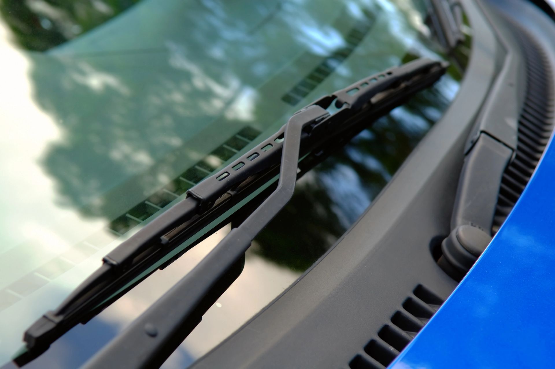 A close up of a windshield wiper on a car