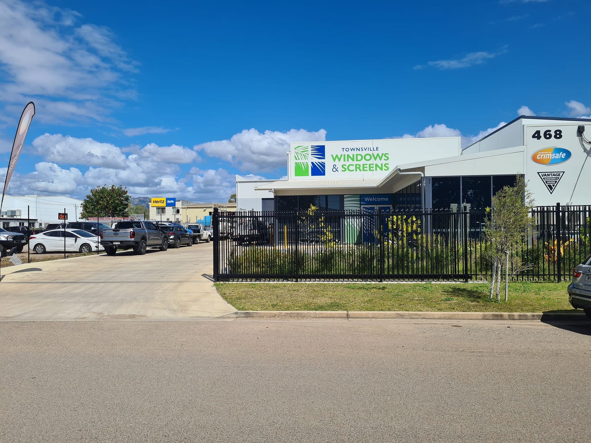 Modern black and white kitchen with a window overlooking a yard.
