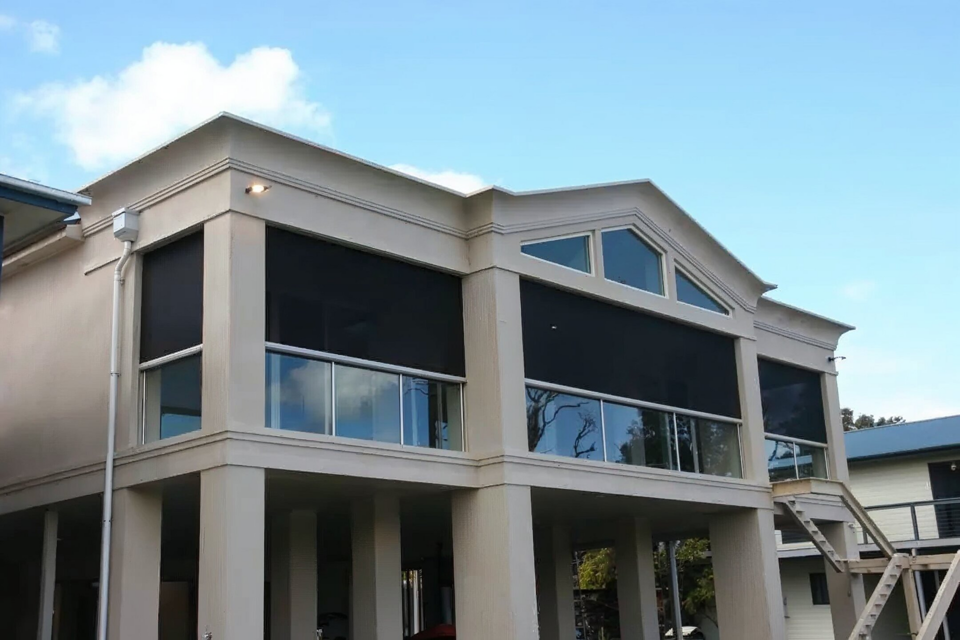 Person using orange suction cups to install glass windowpane.