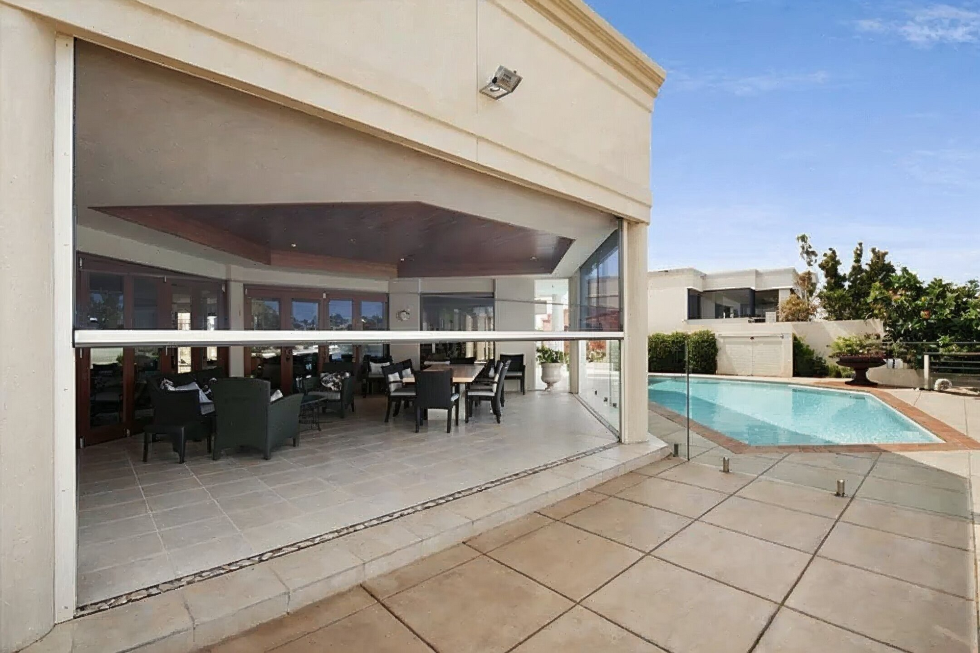 Person using orange suction cups to install glass windowpane.