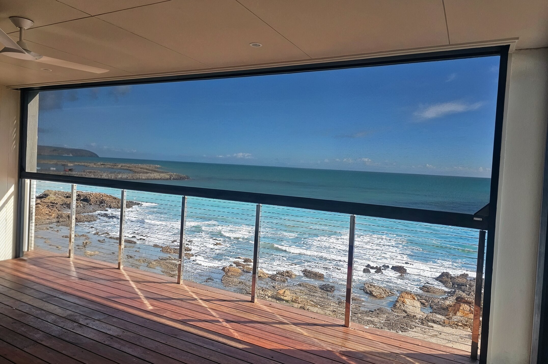 White window frame with handle and latch, screen in the open window.