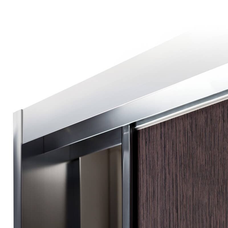 Close-up of a sliding closet door with a dark wood panel and metallic track and frame.