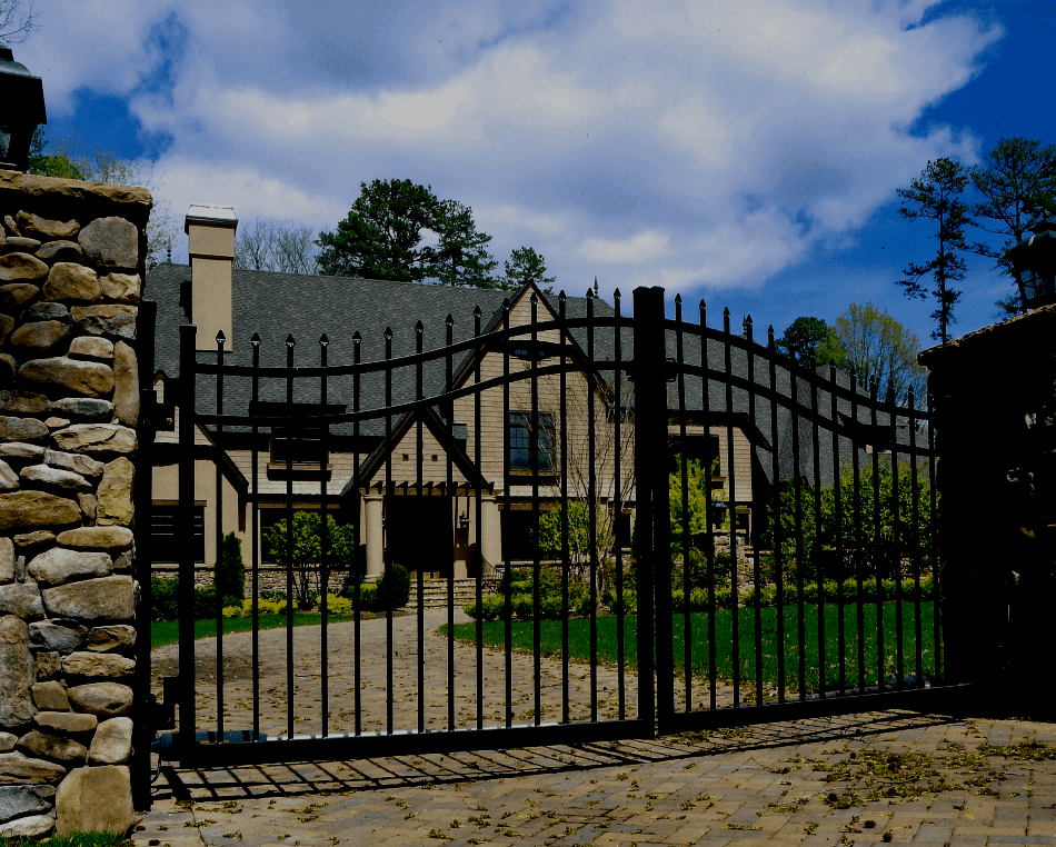 Double estate-style automatic driveway gate with ornamental design.