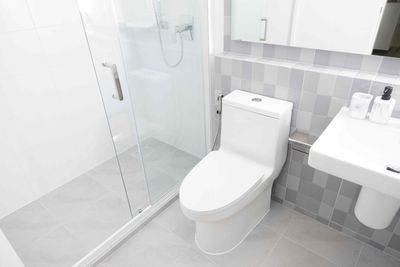 Grande Prairie Handyman: White bathroom with a shower, toilet, and sink.