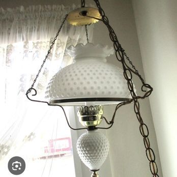 White hobnail glass pendant lamp hanging by chains.