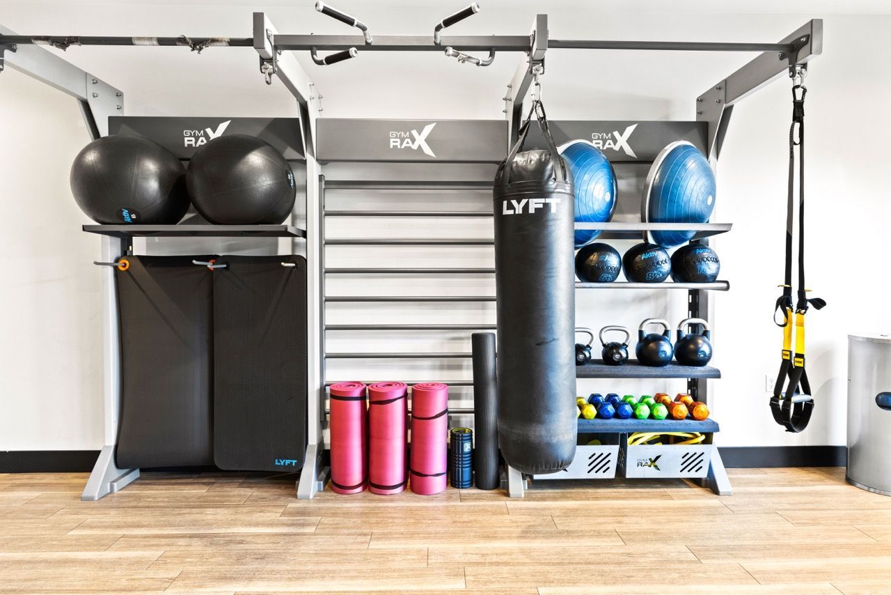On-site gym with weight rack, punching bag, kettlebells, and mats.