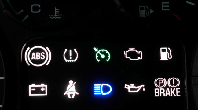A car dashboard with various lights including abs and brake