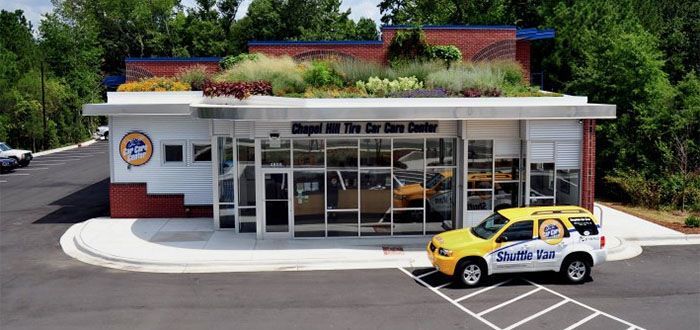 A yellow car is parked in front of a building that says department of the car care center