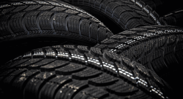 A close up of three black tires stacked on top of each other.