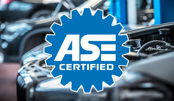 An ase certified logo with a car in the background
