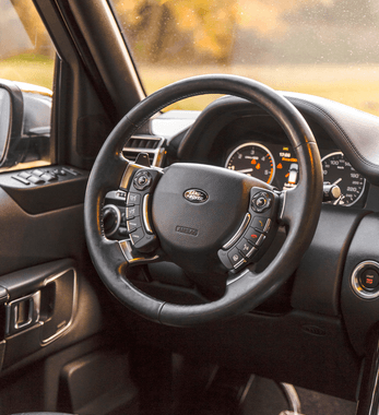 The steering wheel of a land rover is shown