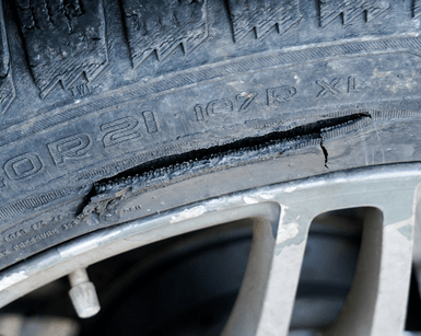 A close up of a tire with a hole in it