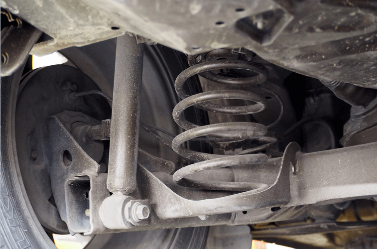 A close up of the underside of a car showing the shock absorber