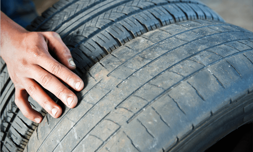 A close up of a person 's hand on a tire