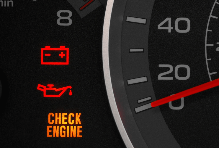 A check engine light is lit up on a dashboard