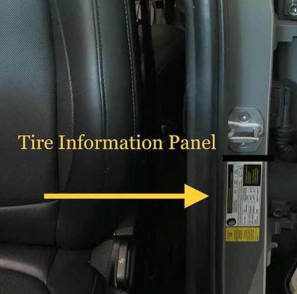 A tire information panel is shown on the side of a car