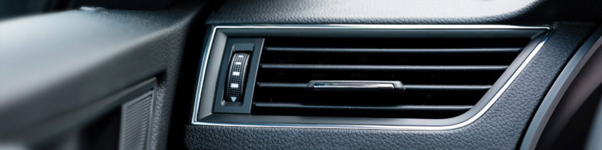 A close up of an air vent on the side of a car.
