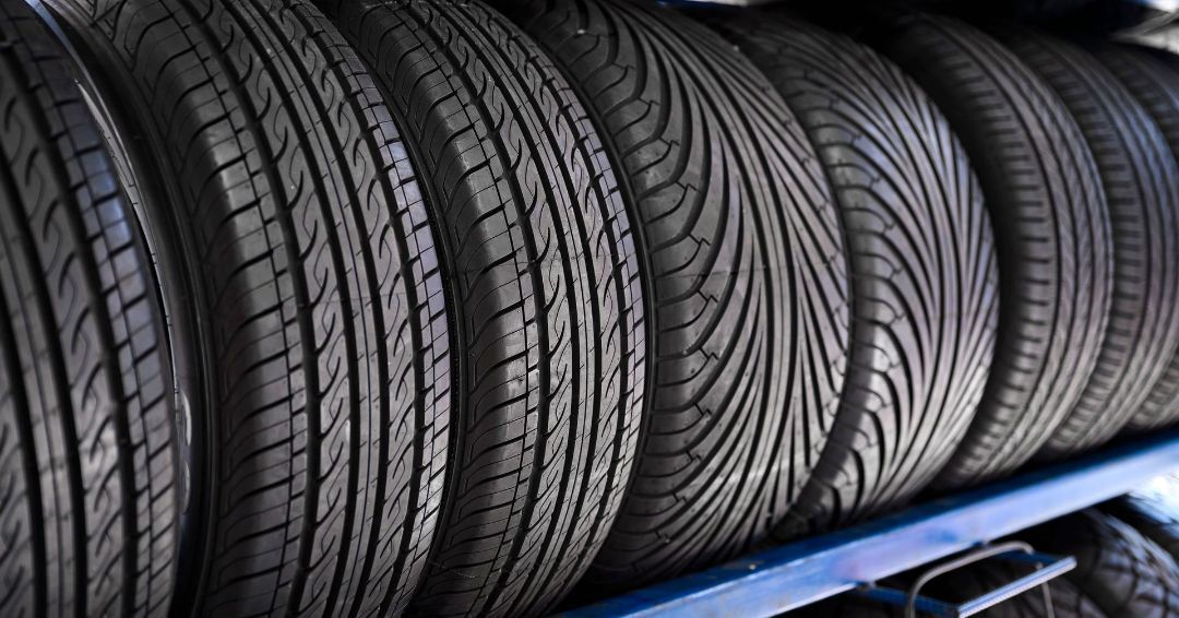 A stack of tires sitting on top of each other on a shelf.