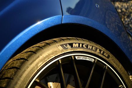 Blue car wheel with a Michelin tire, black rim, close-up shot.