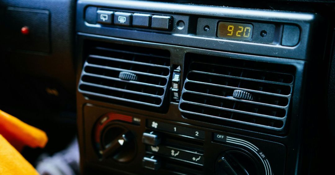 A car dashboard with a digital clock reading 9:20