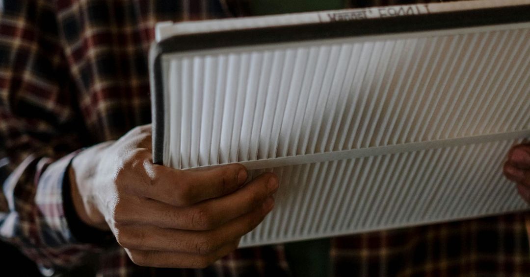 A man is holding a piece of paper in his hands.
