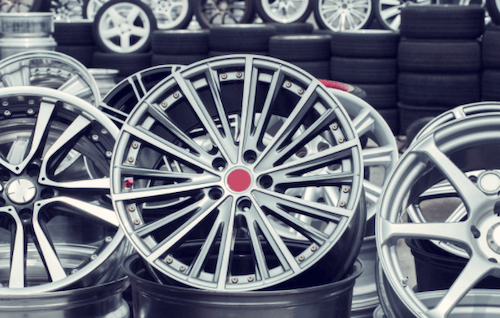 A bunch of wheels are stacked on top of each other in a store.