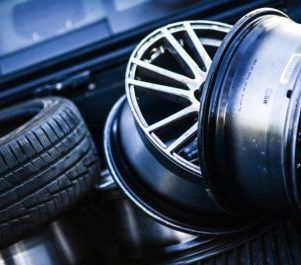 A bunch of wheels and tires are stacked on top of each other.