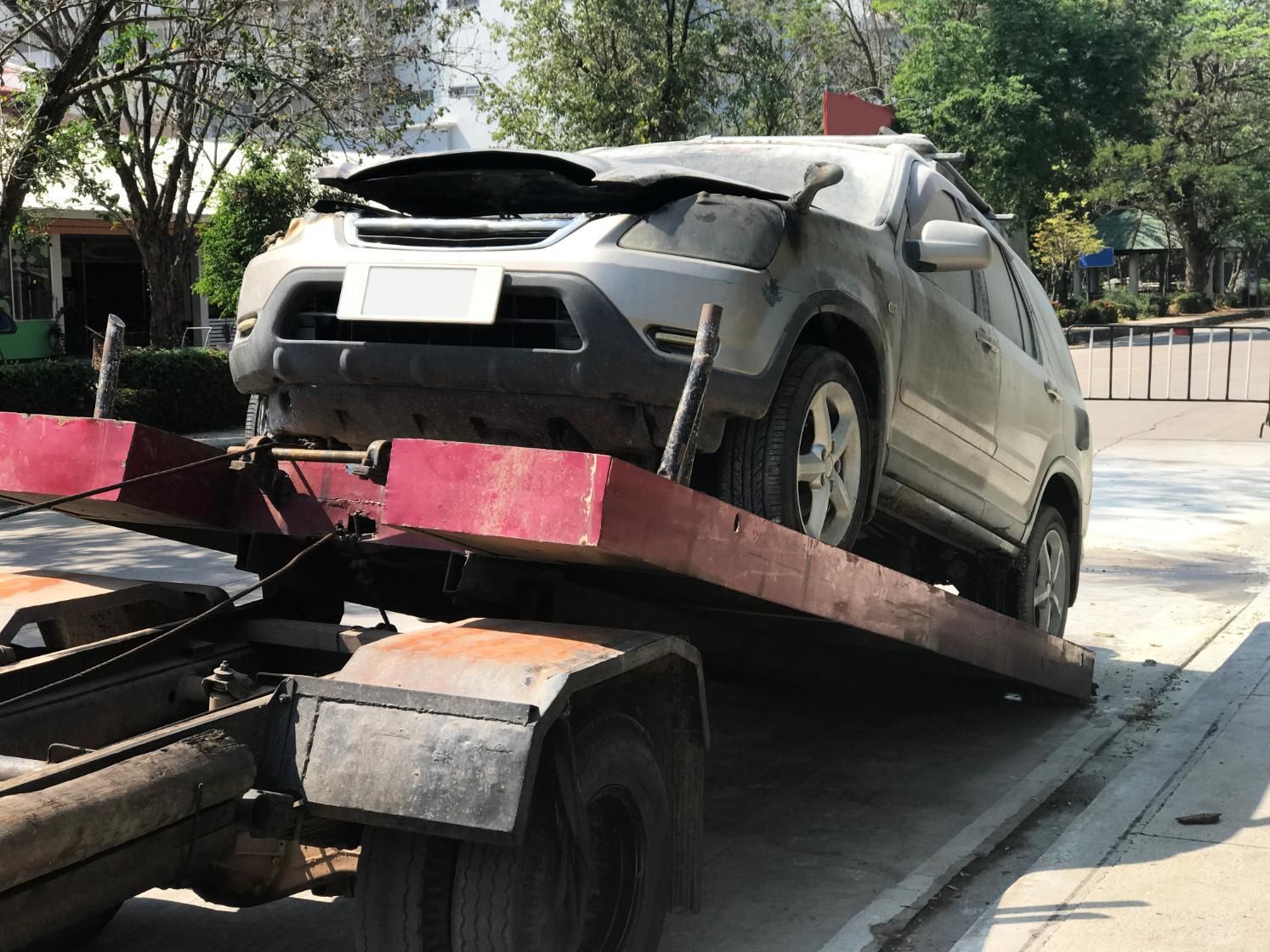 A car is being towed by a tow truck.