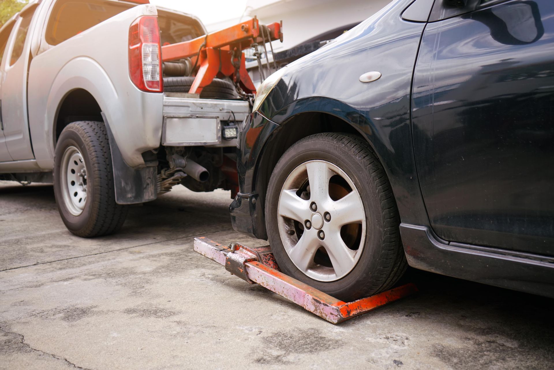 A car is being towed by a tow truck.