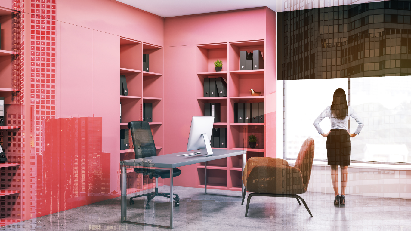 a woman is standing in a pink office with a desk and chair .